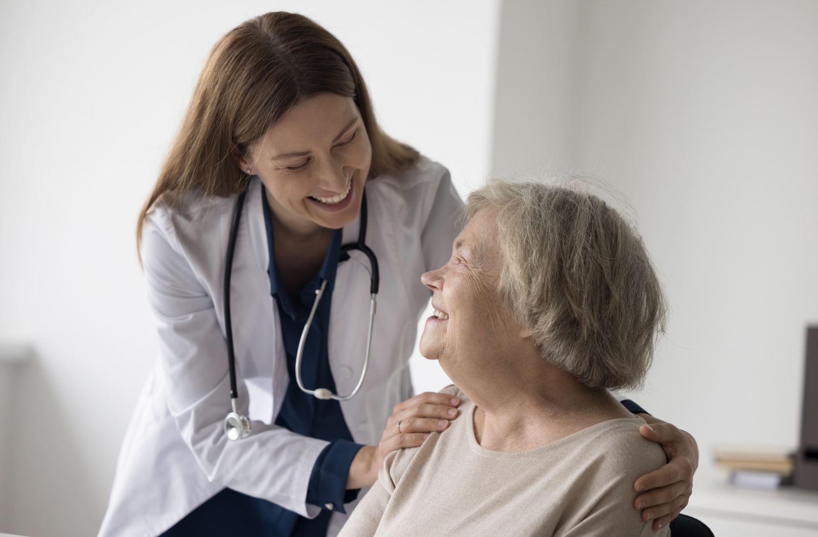 A senior in short term care chatting with her nurse about her transitional care plan.