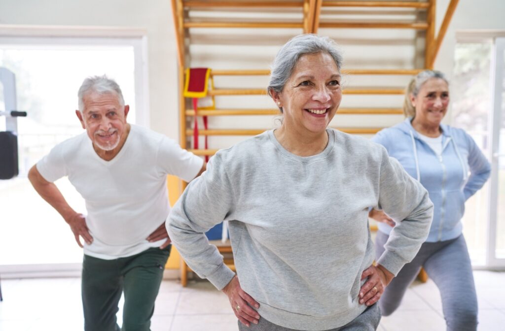 A group of seniors smile as they attend a workout class
